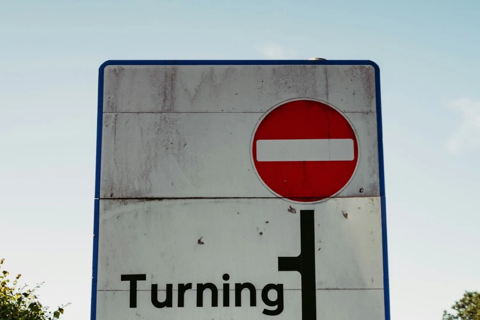 A no-entry roundel on a layout sign reading 'Turning Point'