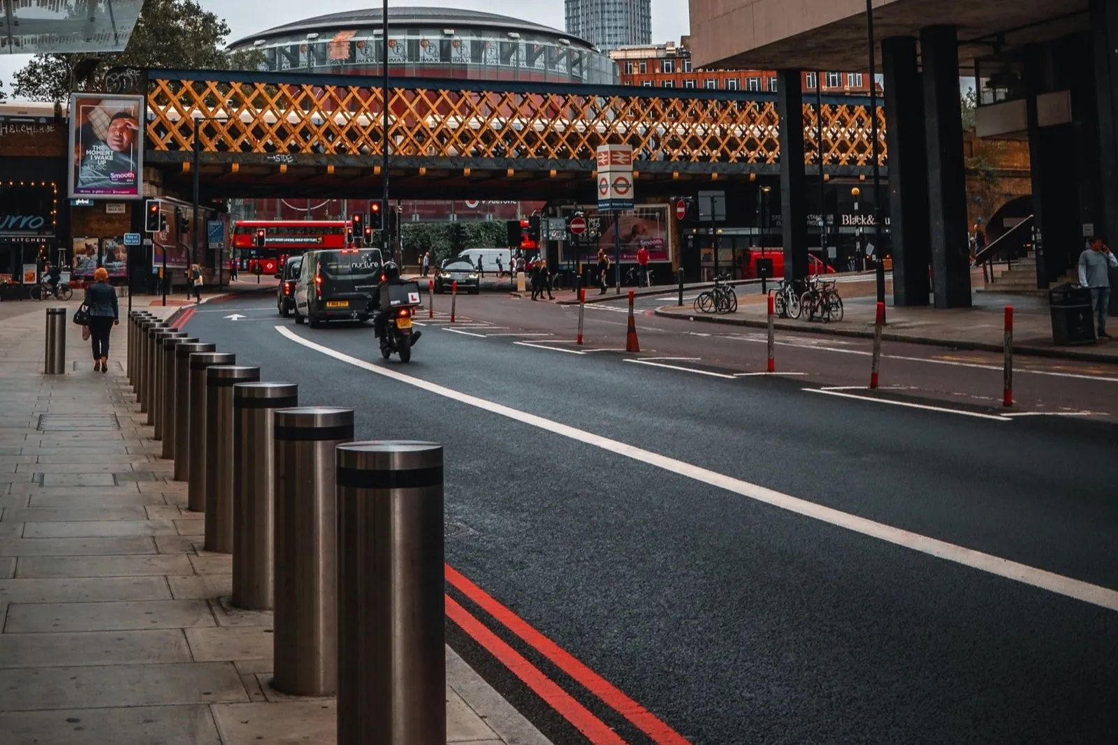 Double red lines along a London red route with steel bollards on the pavement