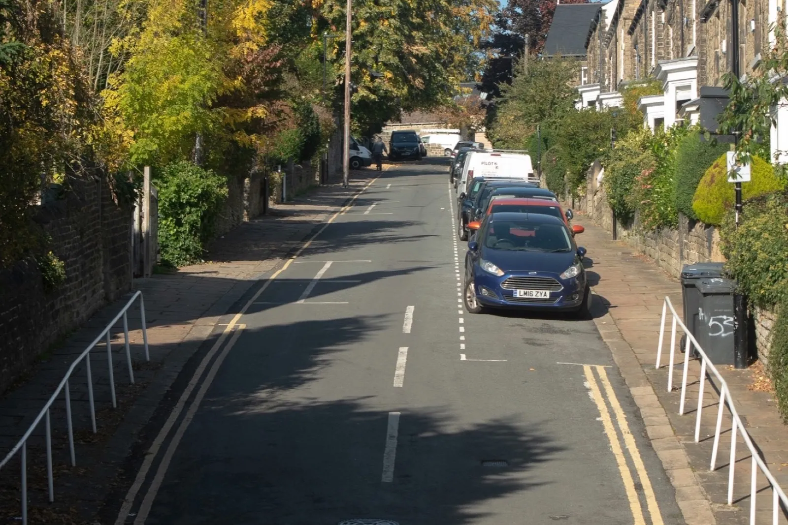 A residential street with a 20 mph roundel painted on the carriageway