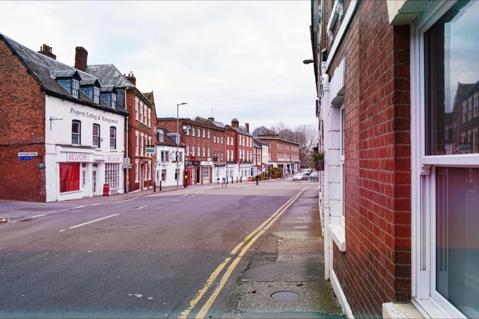 Double yellow lines along the kerb of a town high street