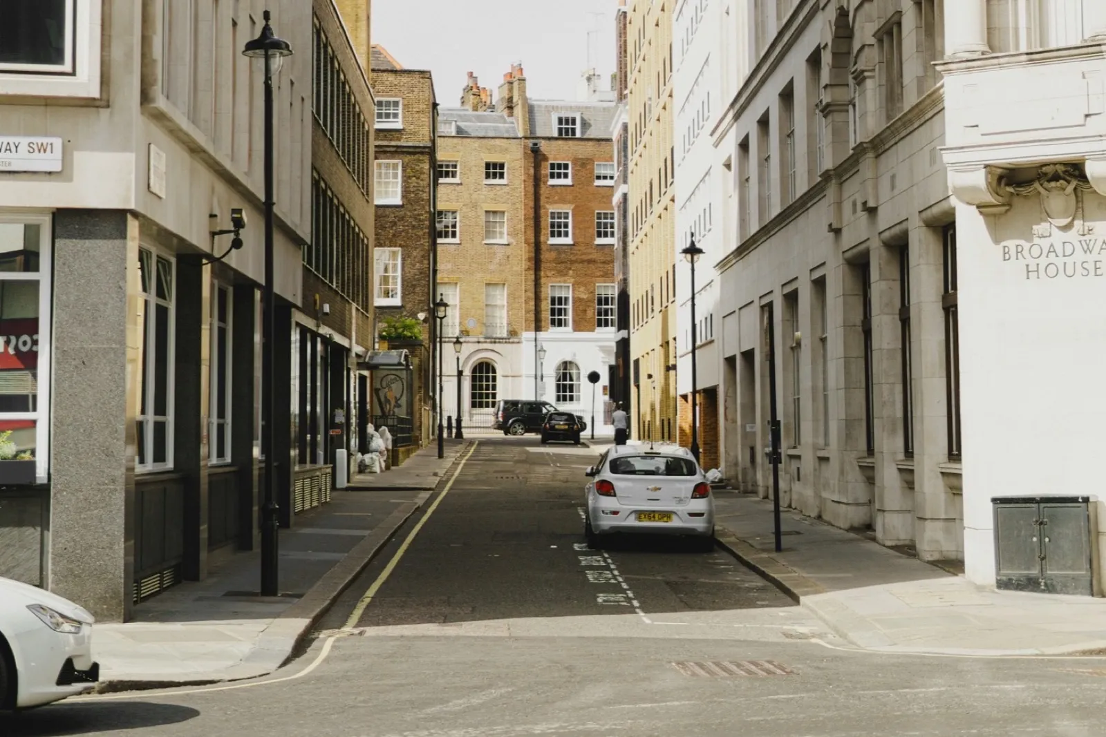 A London side street with a single yellow line and marked parking bays