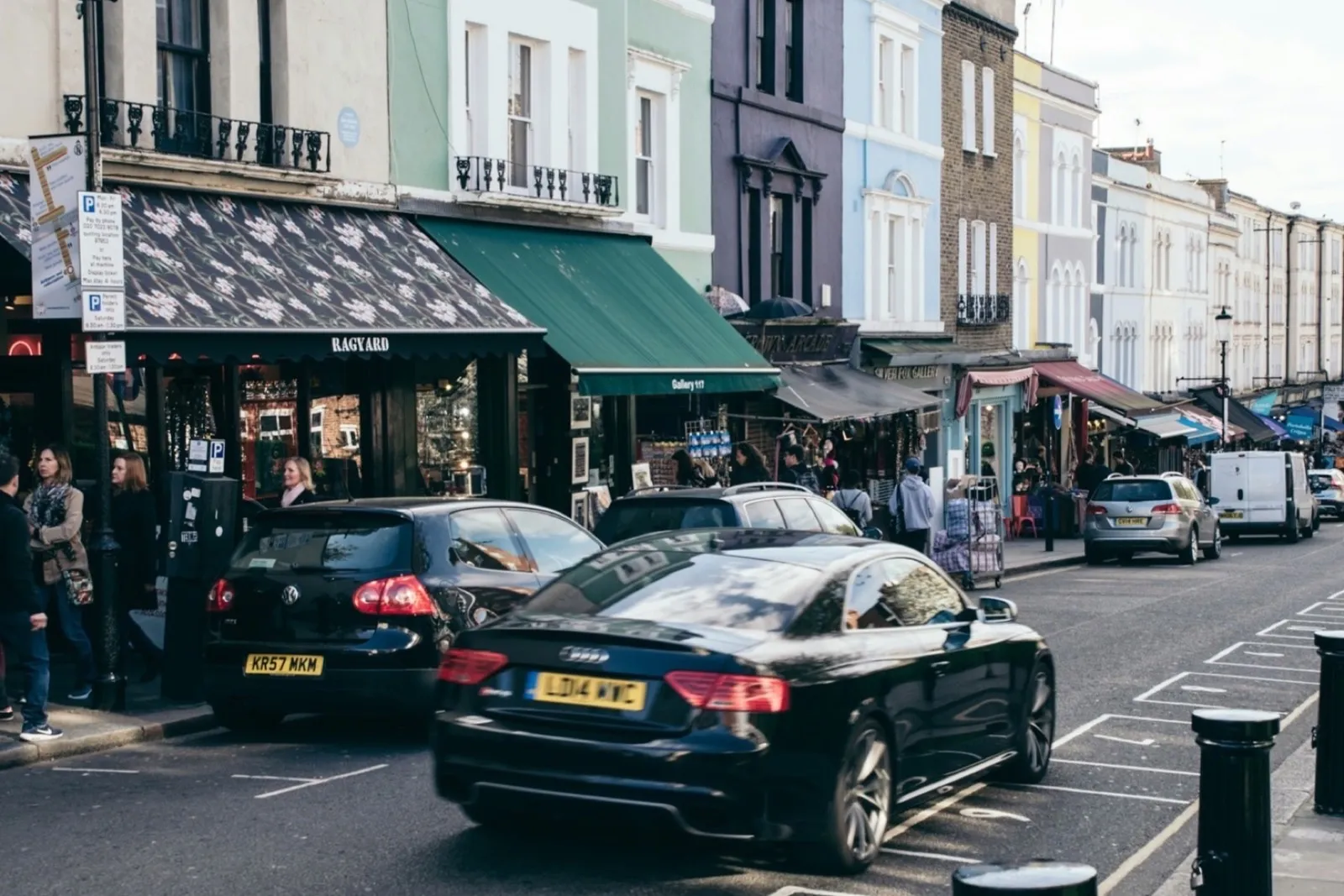 Marked parking bays and kerb restrictions on a busy London shopping street
