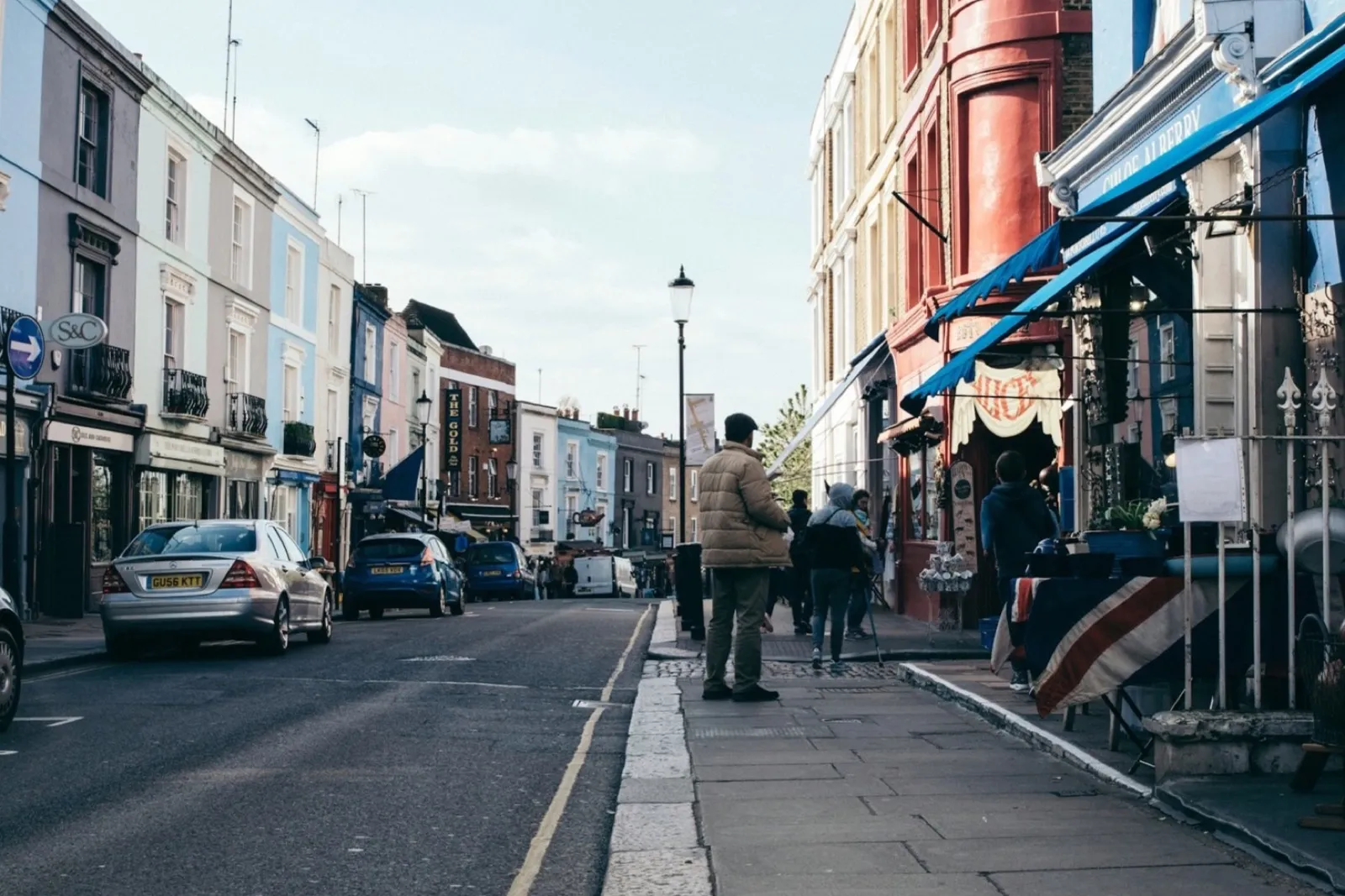 A single yellow line along the kerb of a London shopping street